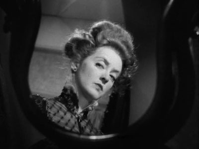 Bette Davis looking in mirror